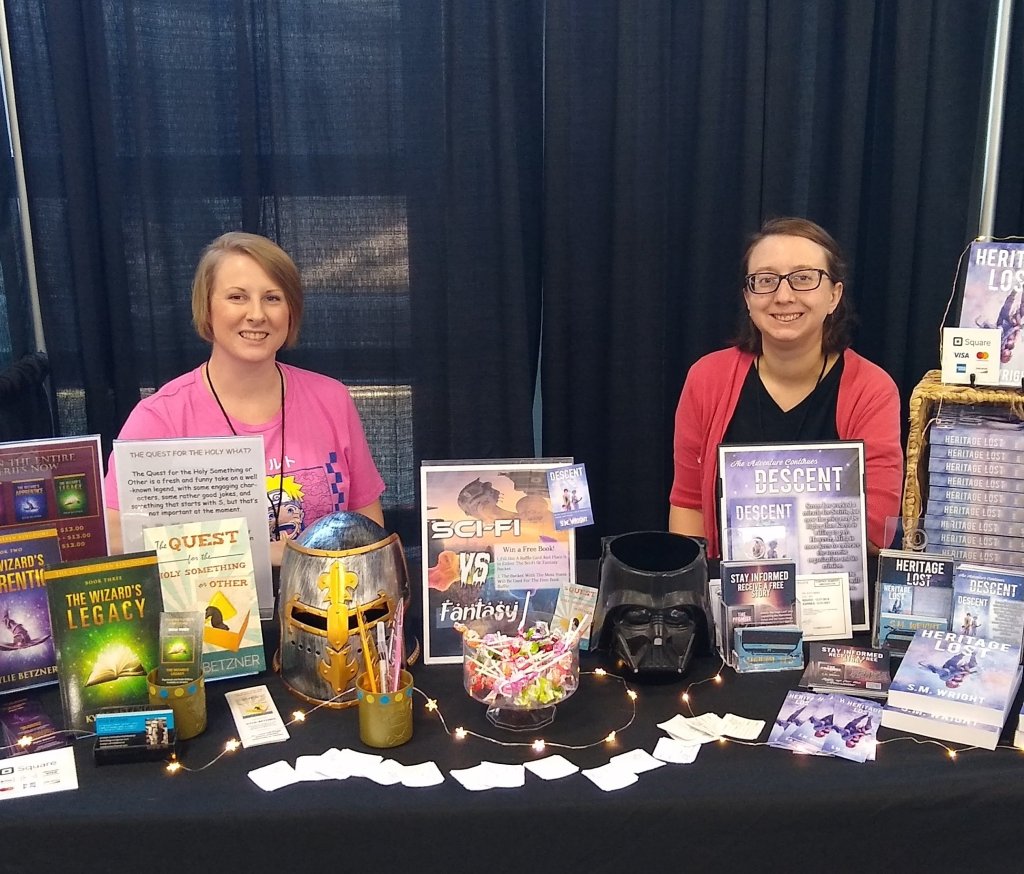 Kylie Betzner and S.M. Wright at Con booth.