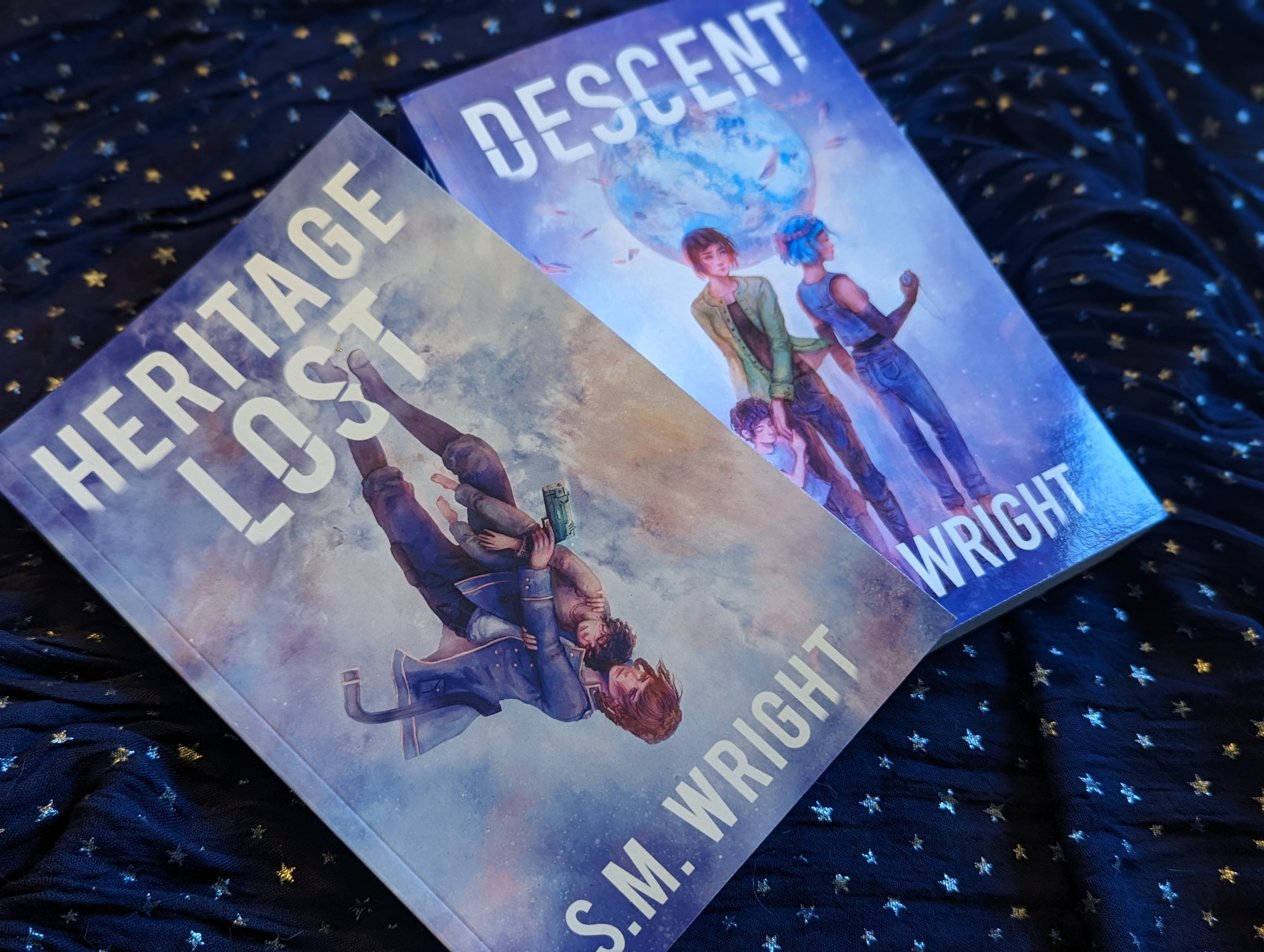 The books Heritage Lost and Descent on a starry fabric